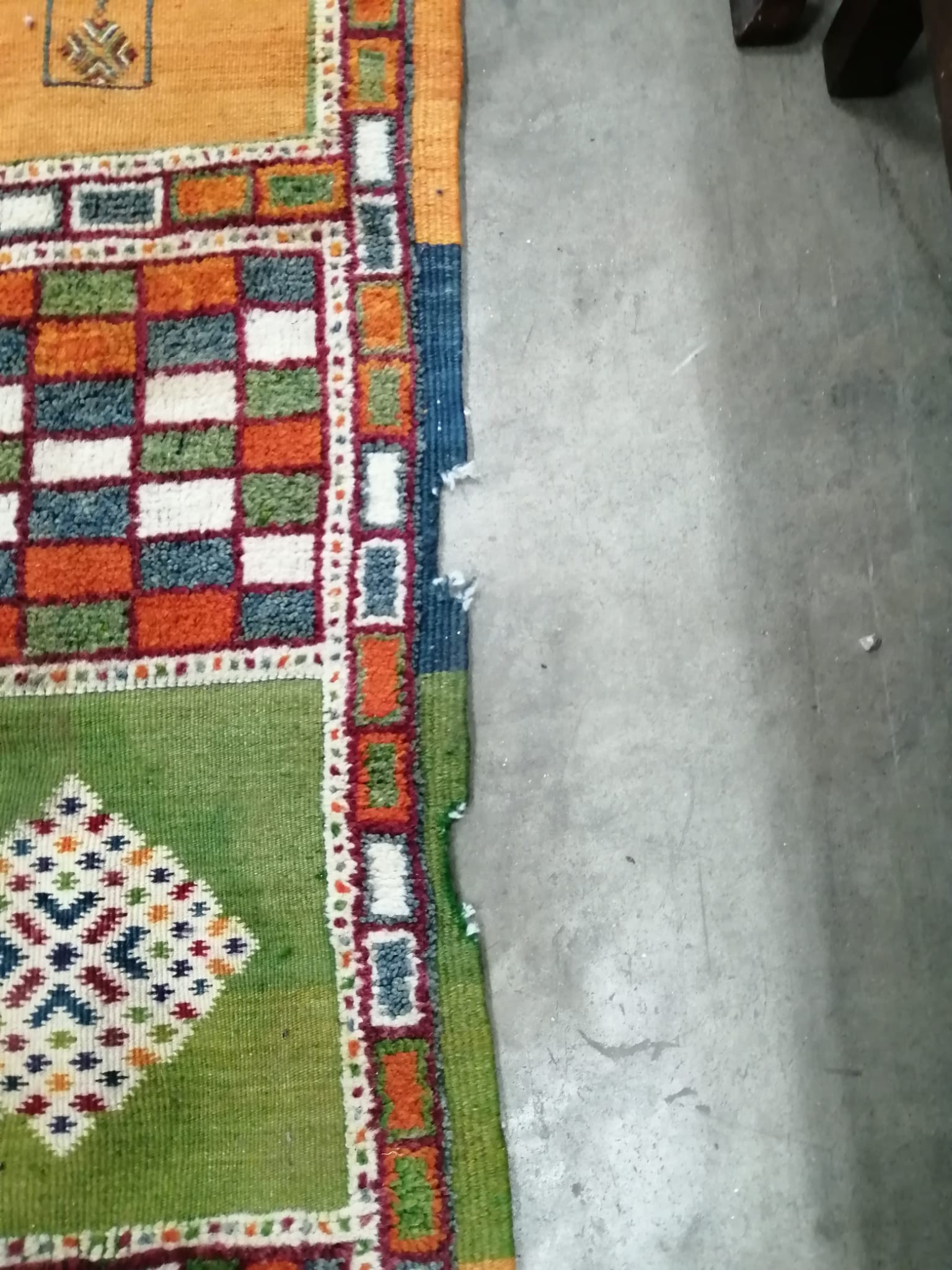 A Caucasian style wool carpet, woven with polychrome geometric squares, 430 x 260cm